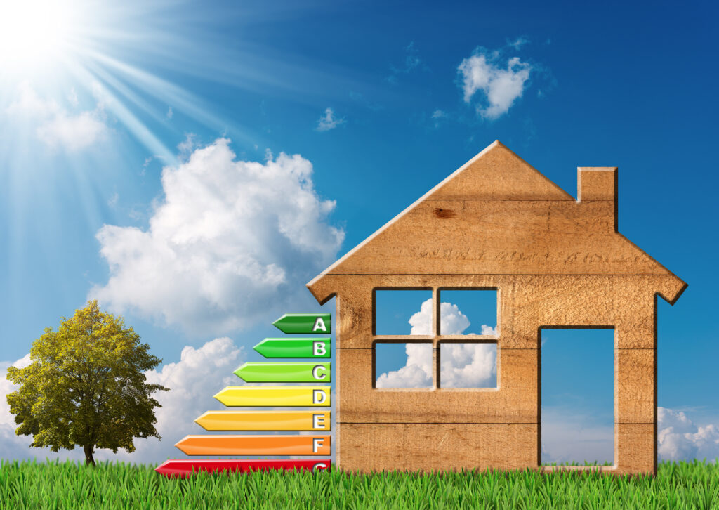 Energy efficiency concept with a graphical house silhouette made of sustainable material on a grass field, energy rating chart leading up to an 'A' grade, symbolizing Sustainable Home Improvements for energy conservation.